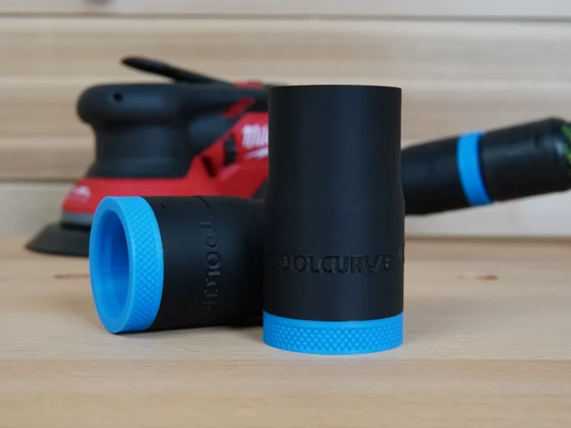 Two black hose adapters with blue grip rings shown with a red Milwaukee random orbit sander in the background
