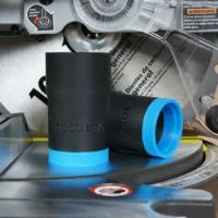 Black ToolCurve hose adapter with blue grip band, displayed on a Ryobi miter saw dust port alongside packaging and documentation