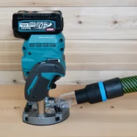 Black 36mm hose adapter with blue band joining a green hose to a Makita 40v XGT plunge router dust port