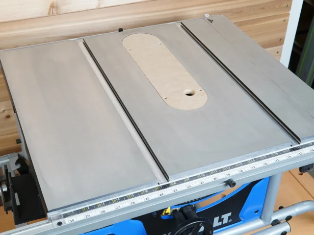 Zero clearance insert mounted on Kobalt 10" table saw, showing rounded cutout for blade with two mounting holes and offset adjustment screws