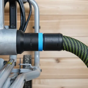 Black hose adapter with blue band linking a green vacuum hose to a Kobalt table saw's dust port