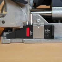 Black stepped imperial thickness gauge marked 1/2" and 1-1/4"/1-1/2" installed on a Festool DF 500 Domino joiner base