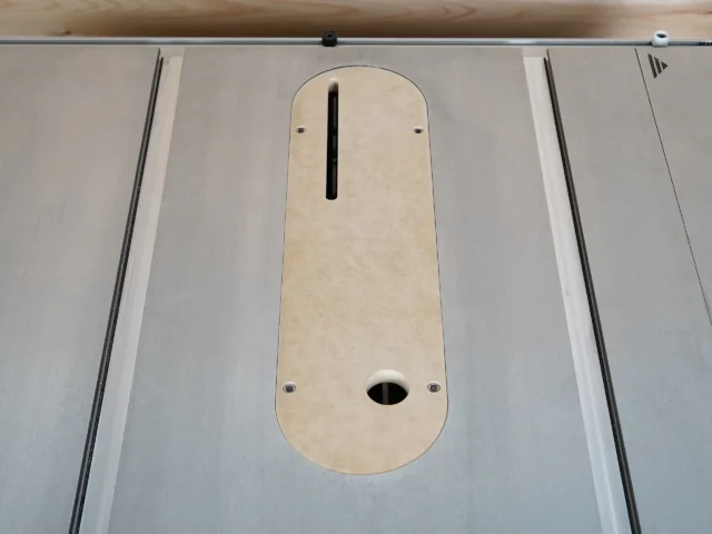 Zero clearance insert for Kobalt table saw, installed in saw table with centered blade slot and oval dust port visible