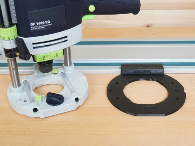 Black guide rail adapter shown alone and mounted on a Festool 1400 plunge router above a wooden work surface