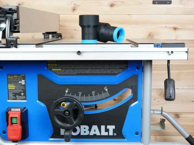 ToolCurve hose adapter with blue and black bands mounted on Kobalt table saw dust port