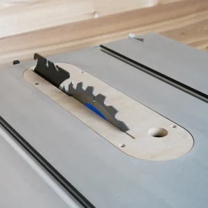 MDF zero clearance insert installed in a Kobalt 10-inch table saw with blade and riving knife raised through the slot