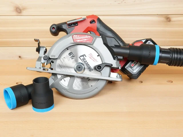 Black 1-7/8 inch ToolCurve hose adapter with blue band installed on a Milwaukee M18 circular saw dust port, second adapter beside it