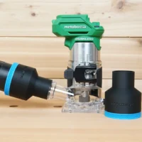 Black ToolCurve 2-1/2 inch hose adapter with blue band beside a Metabo HPT trim router, second adapter on hose