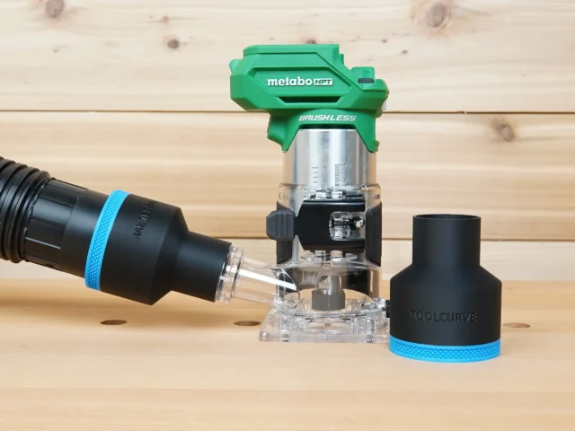 Black ToolCurve 2-1/2 inch hose adapter with blue band beside a Metabo HPT trim router, second adapter on hose