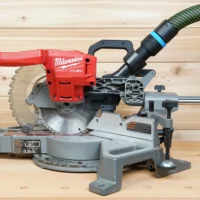 Black 36mm hose adapter with blue band joining an extractor hose to a Milwaukee 7-1/4" miter saw dust port