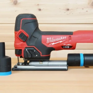 Black ToolCurve hose adapter with blue band beside a Milwaukee M18 Fuel jig saw, second adapter joined to a vac hose