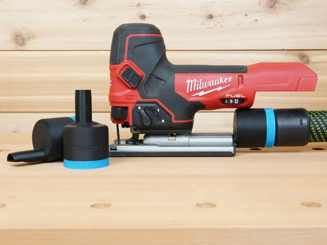 Black 36mm ToolCurve hose adapter with blue band beside a Milwaukee M18 Fuel jig saw, second adapter on hose