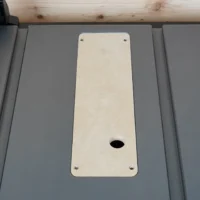 Cream-colored zero clearance insert mounted in SKIL 8-1/4" table saw with centered slot opening and four mounting screw holes