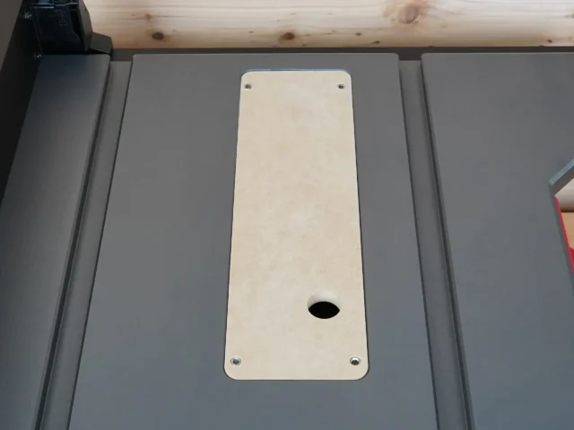 Cream-colored zero clearance insert mounted in SKIL 8-1/4" table saw with centered slot opening and four mounting screw holes
