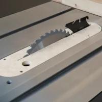 Cream MDF zero clearance insert mounted on Ridgid R4560 table saw, showing black blade guard and offset adjustment screw holes