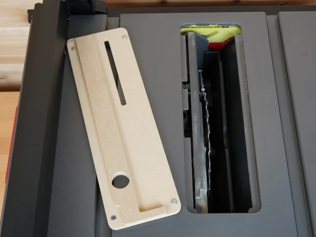 Cream-colored MDF zero clearance insert with slot and mounting holes, positioned next to SKIL table saw throat opening