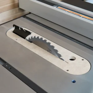 MDF zero clearance insert seated in a Delta contractor table saw with blade raised through the kerf slot
