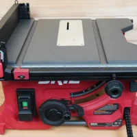 White zero clearance insert fitted into SKIL 8-1/4" table saw with gray top and red base, viewed from above on wooden surface