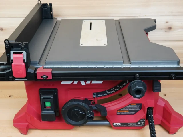 White zero clearance insert fitted into SKIL 8-1/4" table saw with gray top and red base, viewed from above on wooden surface
