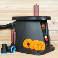 Black ToolCurve 1-7/8 inch hose adapter with blue collar beside a WEN oscillating spindle sander, one adapter connected to a dust hose