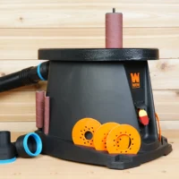 WEN oscillating spindle sander with black ToolCurve 2-1/2 inch hose adapter installed and two spare adapters alongside