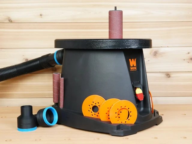 WEN oscillating spindle sander with black ToolCurve 2-1/2 inch hose adapter installed and two spare adapters alongside