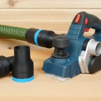 Black ToolCurve 36mm hose adapter pieces with blue trim beside a Bosch PL2632 planer and green hose