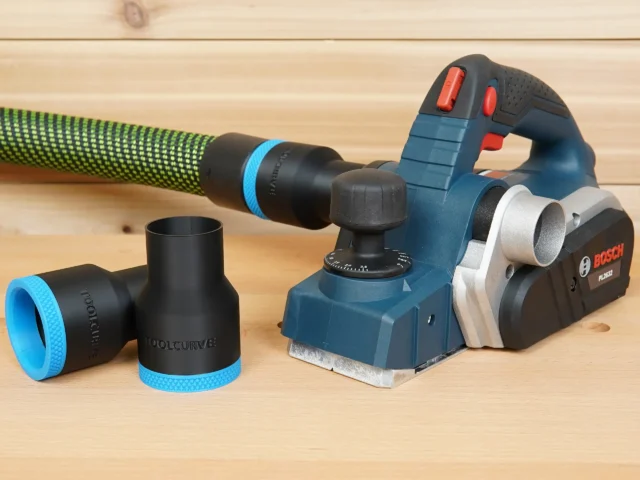 Black ToolCurve 36mm hose adapter pieces with blue trim beside a Bosch PL2632 planer and green hose