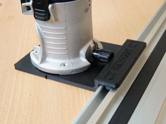 Porter Cable Trim Router mounted on black rail adapter connected to aluminum guide rail
