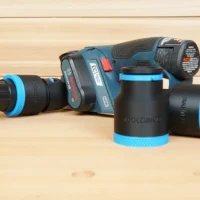 Black and blue ToolCurve 1-7/8 inch hose adapter parts beside a Bosch GHO12V-08 planer, one on a vac hose