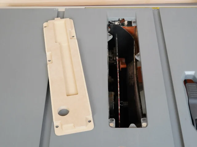 Zero clearance insert for Ridgid R4513 table saw shown front and back; cream-colored MDF face with rectangular recess and mounting holes, black interior with metal hardware visible