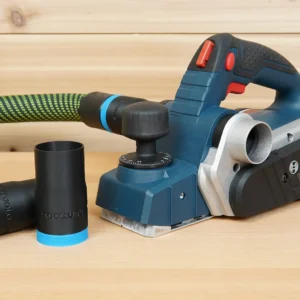 Black ToolCurve hose adapter with blue collar lying beside a Bosch PL2632 planer and green vac hose