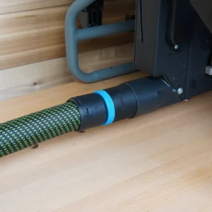 Black ToolCurve hose adapter with blue ring joining a green braided vacuum hose to a Craftsman table saw dust port