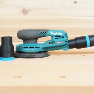Black and blue ToolCurve hose adapter beside a Makita 40V XGT sander with extractor hose connected