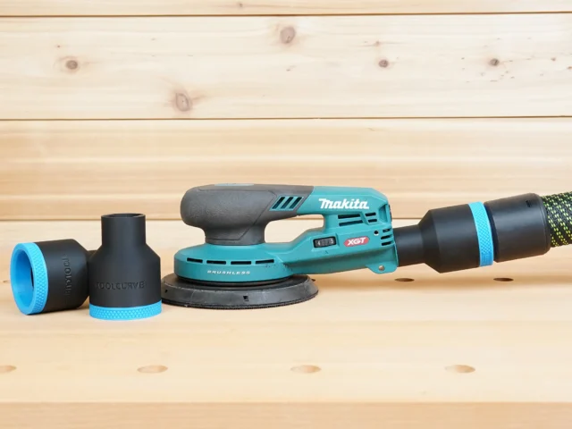 Black 36mm ToolCurve hose adapter installed on a Makita 40V XGT sander dust port, with a second adapter beside it