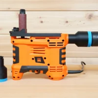 Black 36mm hose adapter with blue collar shown beside an orange WEN spindle sander connected to a vacuum hose