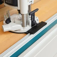 Guide Rail Adapter for OF 1010 Router mounted on Festool track saw guide rail, showing black adapter plate and white base with adjustment knobs