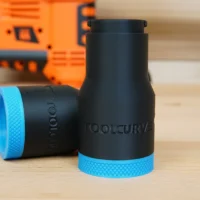 Black cylindrical hose adapter with blue grip rings, labeled ToolCurve, displayed upright with a second adapter lying on its side