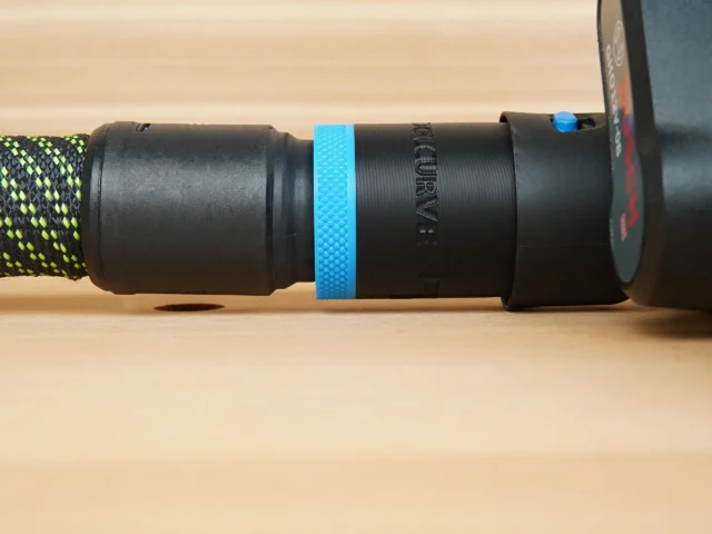 Hose adapter attached to Bosch planer outlet with blue band around connection, green and yellow braided hose visible on left