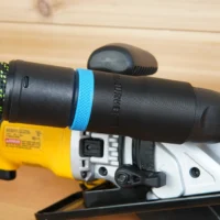Hose adapter with blue band attached to Dewalt Atomic circular saw dust port