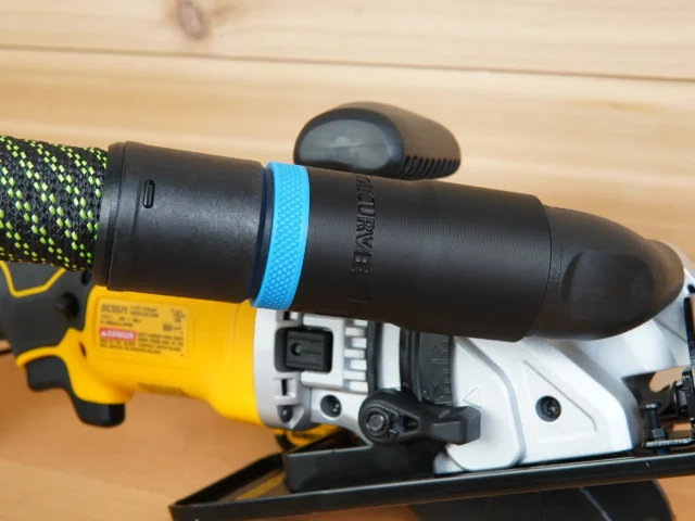 Hose adapter with blue band attached to Dewalt Atomic circular saw dust port