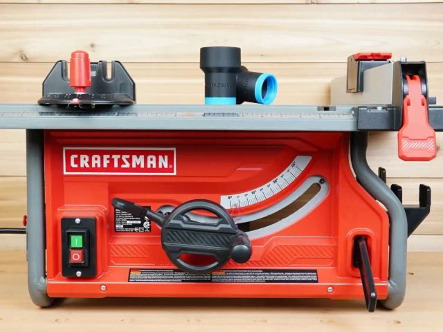 ToolCurve hose adapter with blue ring and black cylindrical body, displayed on Craftsman table saw dust port