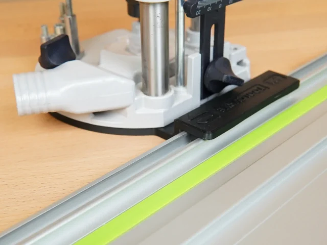 Black ToolCurve adapter mounted on Festool guide rail, attached to OF 1010 router base above the rail