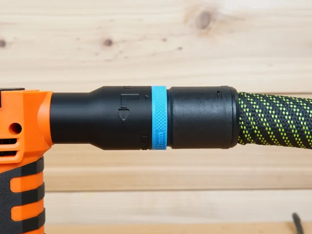 Blue hose adapter attached to WEN handheld spindle sander with green braided hose connected on the right side