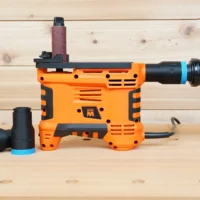 Black 1-1/4" ToolCurve hose adapter with blue collar installed on orange WEN spindle sander, second adapter beside it