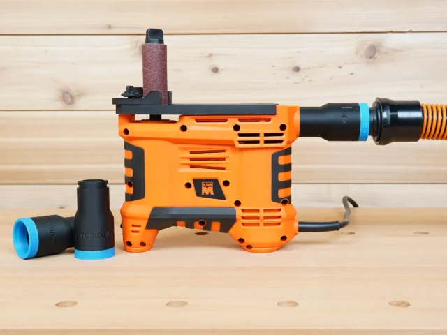 Black 1-1/4" ToolCurve hose adapter with blue collar installed on orange WEN spindle sander, second adapter beside it
