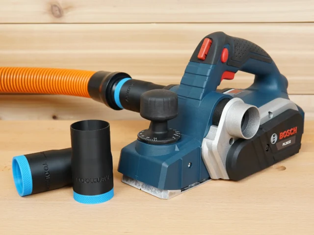 Black 1-1/4 inch hose adapter with blue collar beside a Bosch PL2632 planer, orange hose attached above
