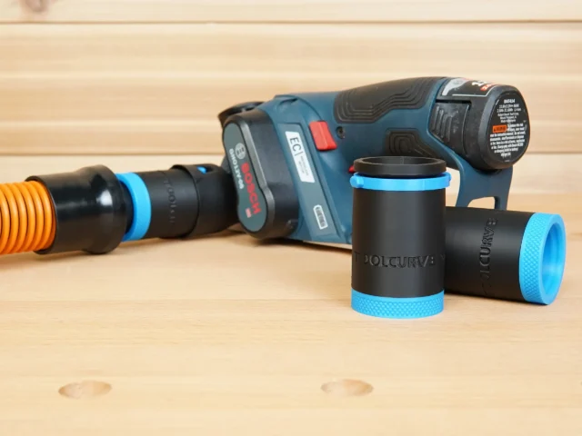Two black 1-1/4" hose adapters with blue knurled ends beside a Bosch 12V MAX planer and orange hose