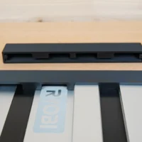 Black PETG protective caps for Ryobi guide rail, one cap installed on rail end and one cap shown separately