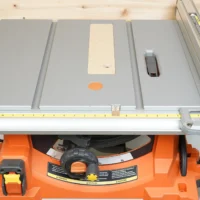 Zero clearance insert installed on Ridgid R4513 table saw, showing cream-colored MDF insert flush with gray aluminum table surface and blade opening